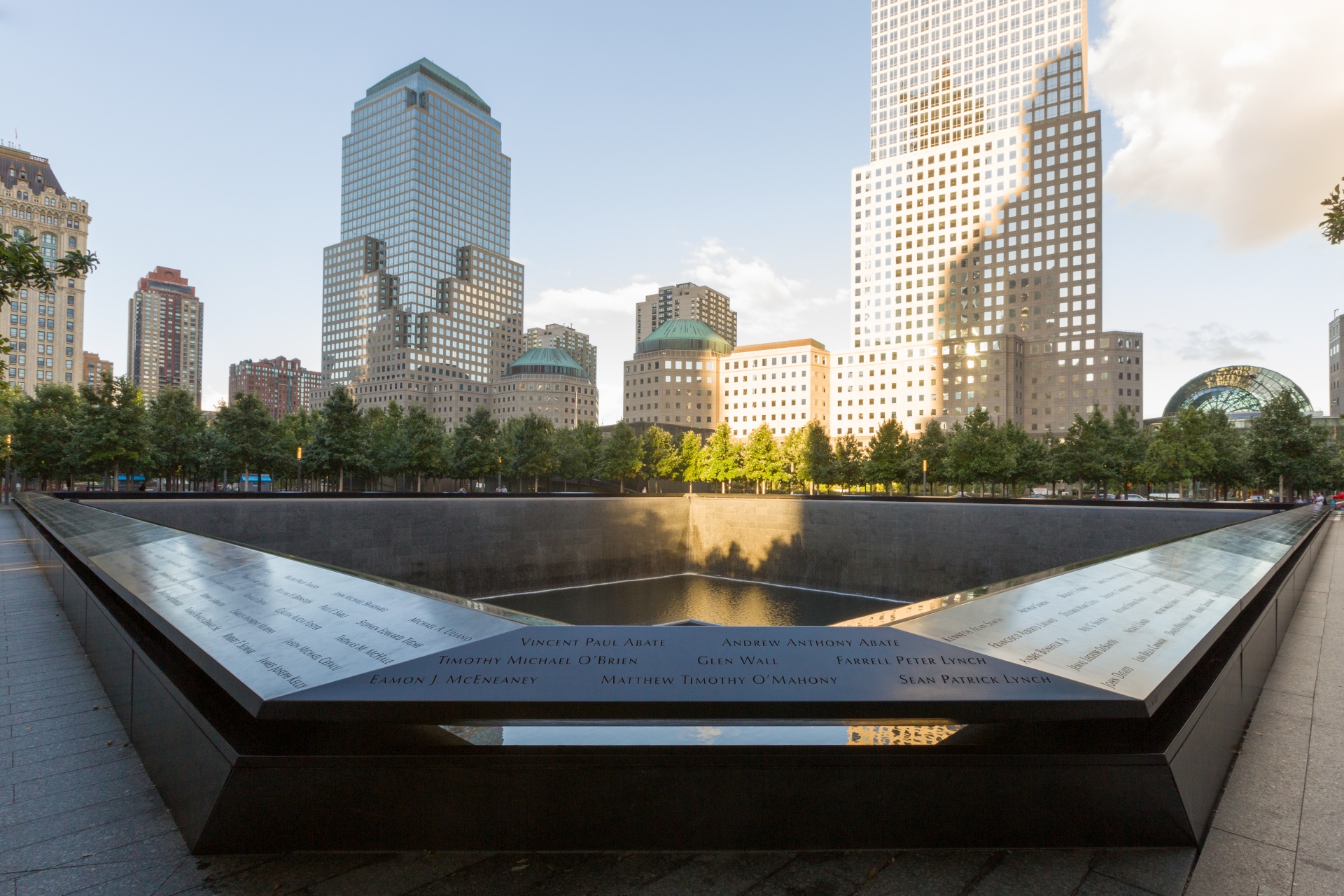 Bronze parapet inscribed with victims' names at the North Pool, National September 11 Memorial, New York City