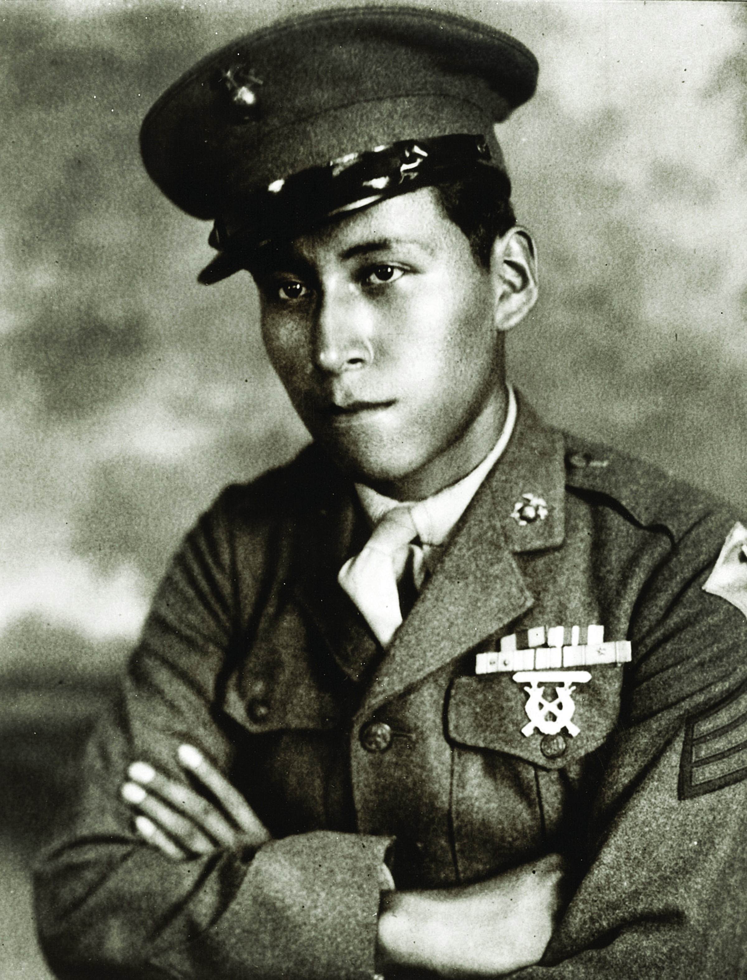 Cpl. Mitchell Red Cloud Jr. in uniform, arms crossed